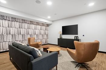 a living room with a couch and chairs